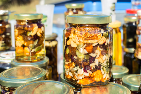 Close Up Honey Jar Packed With Pumpkin Seeds Walnuts Almonds Figs And Other Nuts And Dried Fruits...