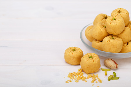 Round shaped Chickpea cookie pastries made of gram flour and pistachio traditional Iranian Sweets: Nokhodchi close up shot and empty space for typing your textsの写真素材