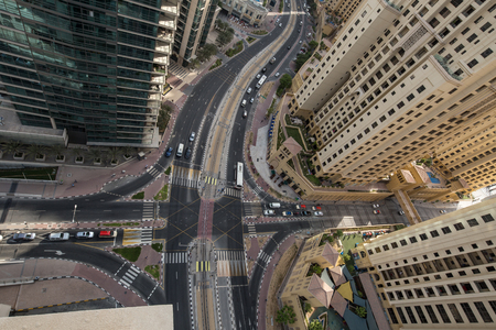 View form the top looking over a junction with road traffic in Dubai Marina
