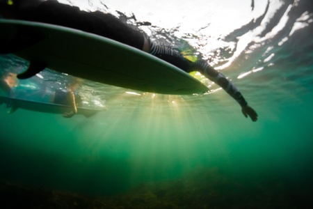 View of two surfers paddling from underwater shotの写真素材