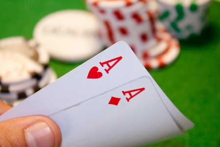 Pocket aces pair with stack money in the backgroundの写真素材