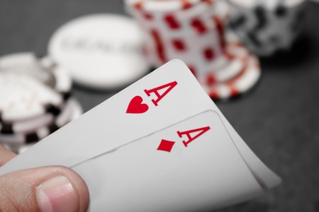Pocket aces hand red isolated with stack in the backgroundの写真素材