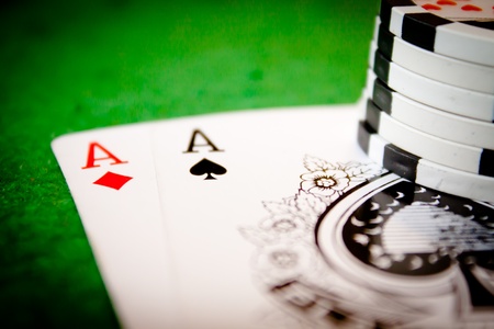A pair of aces with stack and green backgroundのeditorial素材