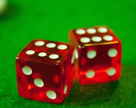 Two red and white dices double six with green backgroundの写真素材