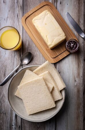 Preparation of a spread with butter and red fruit jamの写真素材