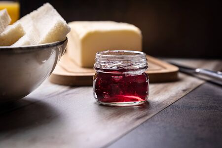 Preparation of a spread with butter and red fruit jamの写真素材