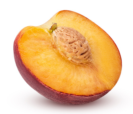 Ripe peach fruit cut in half with bone isolated on white backgroundの写真素材