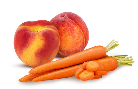 Two peach and carrots with slice isolated on white background. Clipping Path. Full depth of field.の写真素材