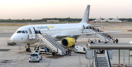 BARCELONA, SPAIN - JULY 16, 2015: Passengers are boarding on a Vueling Airbus A320 in El Prat...