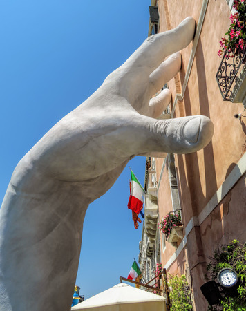 Venice, Italy - June 20, 2017: Monumental hands rise from the water in Venice to highlight climate changeのeditorial素材