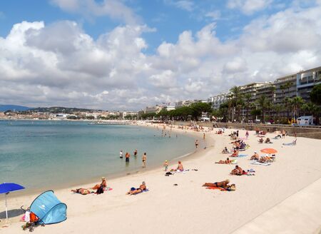 Cannes, France - June 28, 2018: Vacationers enjoy the beautiful weather at the public beach at the end of the Promenade de la Croisetteのeditorial素材