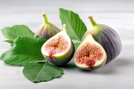 Ripe appetizing figs with green leavesの素材