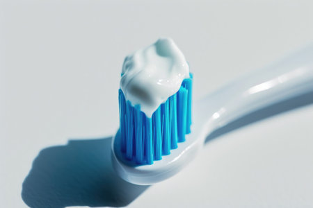A toothbrush featuring toothpaste neatly squeezed onto its bristle headの素材