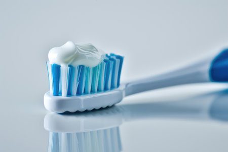 A toothbrush featuring toothpaste neatly squeezed onto its bristle headの素材