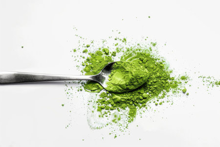 A spoonful of vibrant matcha powder on a white backgroundの素材