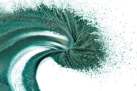 Spirulina powder spiraling elegantly on a white backgroundの素材