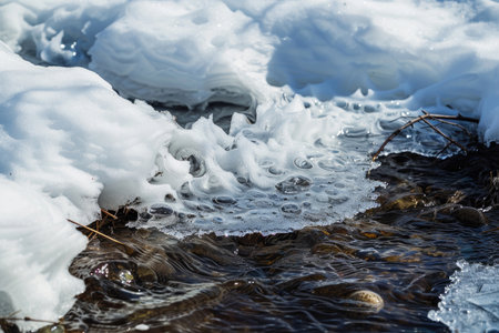 A captivating image of snow melting and revealing the vibrant landscape beneathの素材