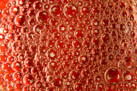 Red bubbles and drops of water on a white background star from an American flag.