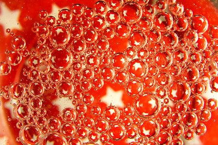 Red bubbles and drops of water on a white background star from an American flag.の写真素材