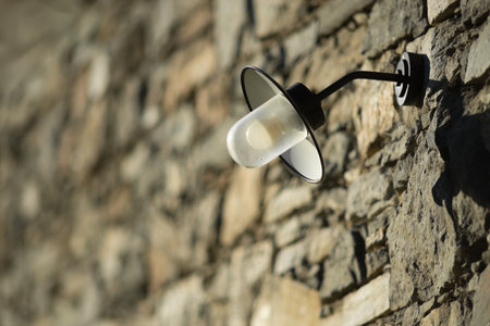 Lamp on a stone wall. Shallow depth of field.