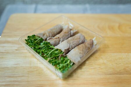 Sliced Pork with Kaiware Roll in Plastic Boxの写真素材