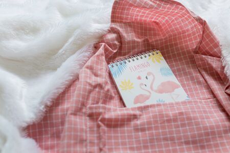 Pink flamingo notebook with To do list set on pink grid cloth