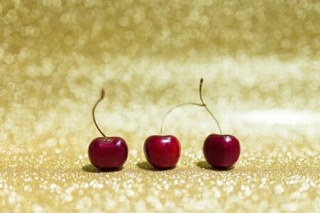 Three Cherry on glitter background