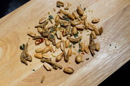 Disrupted Peanuts Mixed Anchovy on wood Plateの写真素材