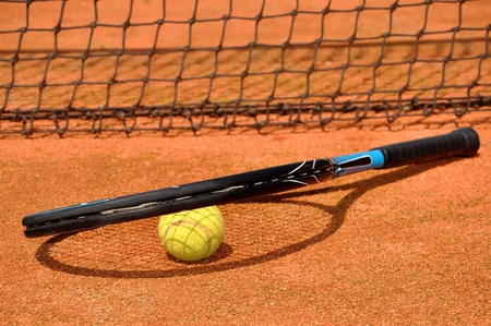Tennis ball and racket on the court の写真素材