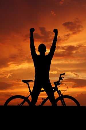 mountain biker silhouette in sunrise の写真素材