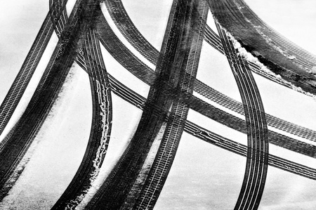 Tracks of car tires in thin layer of first snow の写真素材