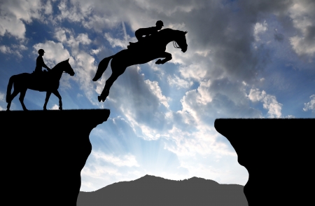 silhouette of a rider on a jumping horseの写真素材