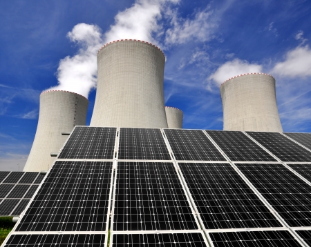 Solar energy panels before a nuclear power plant の写真素材