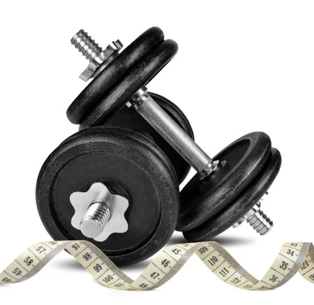 Black dumbbells with measuring tape isolated on whiteの写真素材
