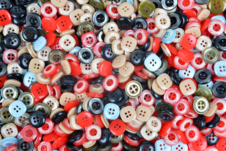 Closeup of a pile of buttons of many colors