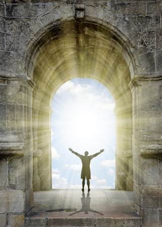 Man standing in front of the gate to heaven.の写真素材