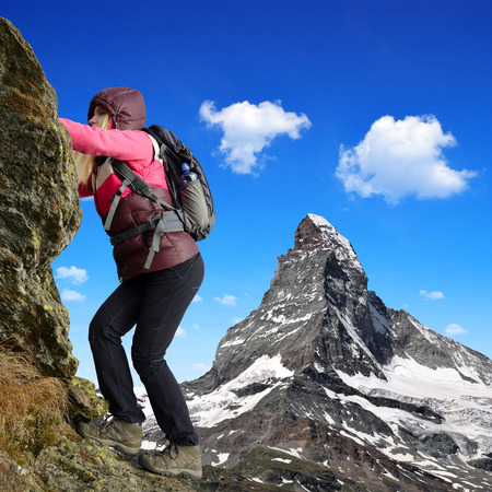 Girl on rock, in the background mount Matterhorn - Swiss Alps, Europeの写真素材