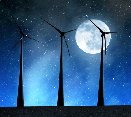 Wind turbines in the night sky with moonの写真素材