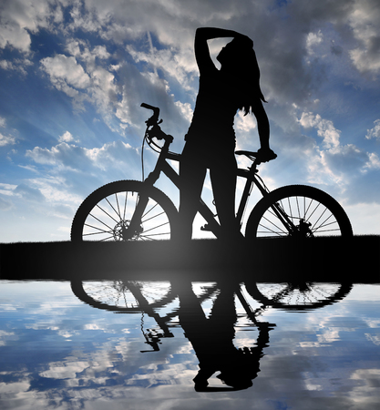 Girl on a bicycle in the sunsetの写真素材