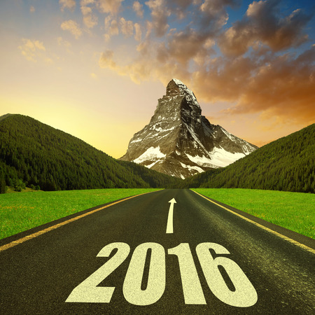 Asphalted road in mountain landscape at sunset. Forward to the New Year 2016
