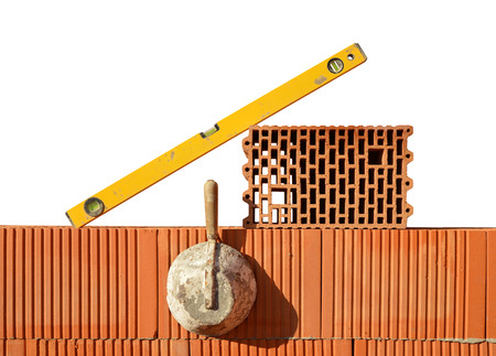 Masonry tools on red brick wall. Bricklaying work.