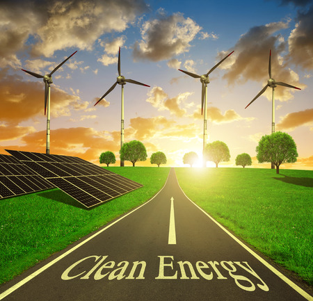 Solar energy panels and wind turbines at sunset. Clean energy concept.の写真素材