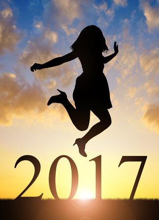 Girl jumps to the New Year 2017 at sunsetの写真素材
