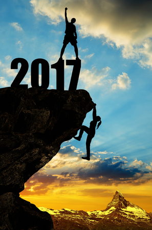 Hiker climbs into the New Year 2017 at sunset.の写真素材