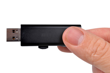 Flash drive in hand isolated on white backgroundの写真素材