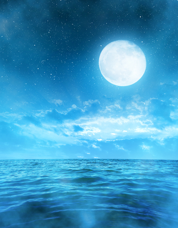 Romantic night sky with full moon above the sea.の写真素材