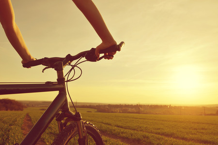 Cyclist on bike in the sunset.の写真素材