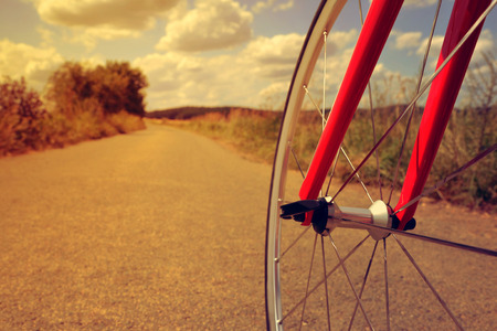 Road bike in the rural landscape at sunset.