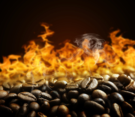 Roasted coffee beans with fire on the background.の写真素材