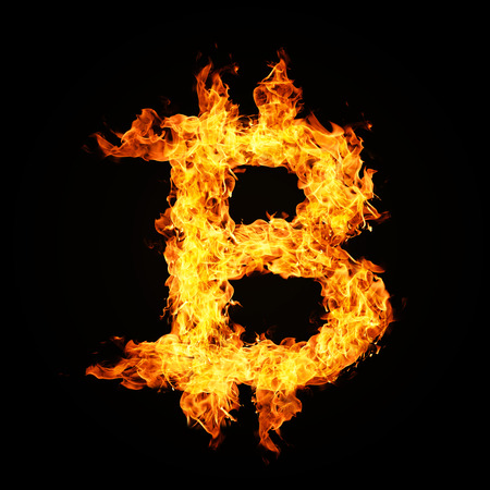 Crypto currency Bitcoin icon from fire flame isolated on black background.の写真素材